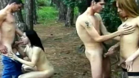 Two slender shemales Make A blowjob-stimulation And lick assholes For Two men In The Forest